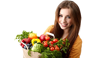 woman-holding-a-bag-full-of-healthy-food.-shopping